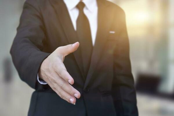 businessman offering his hand for handshake in office concept of welcome for collaboration introduction selective focus free photo